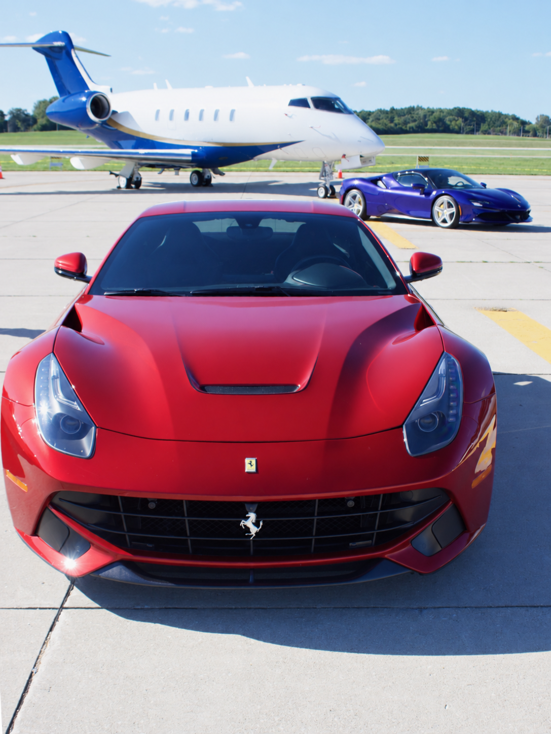 Red Ferrari in front of a private aircraft